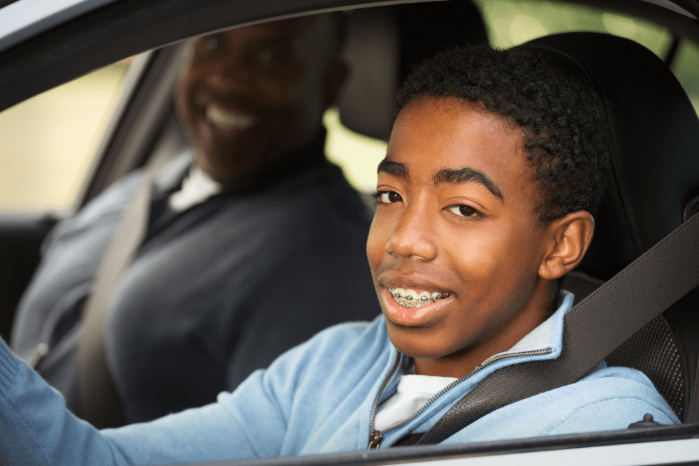Teenager Driving a Car with Parent